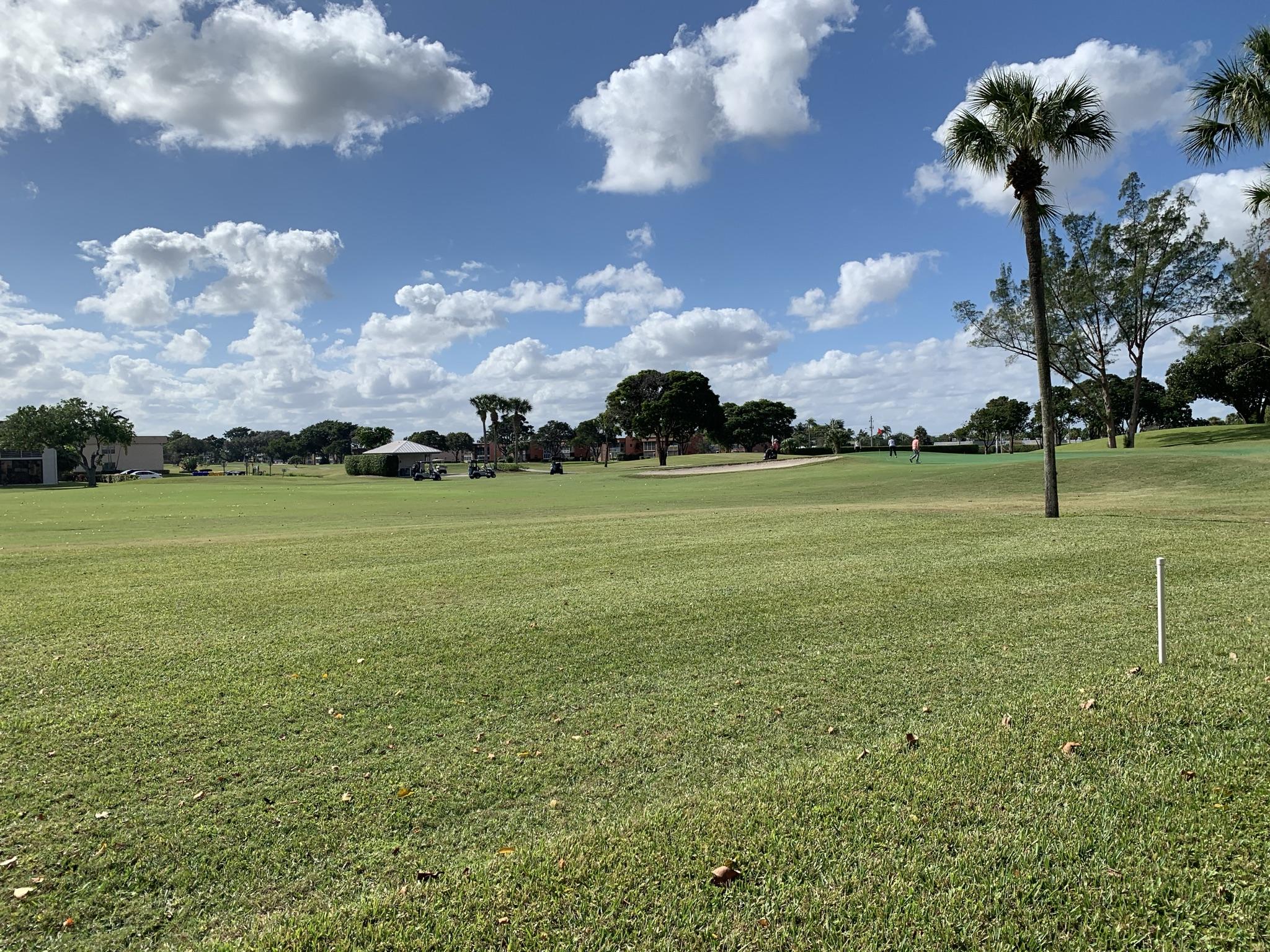 82 Normandy B Delray Beach, FL 33484 - Photo 16 of 31 a front view of a house with a big yard