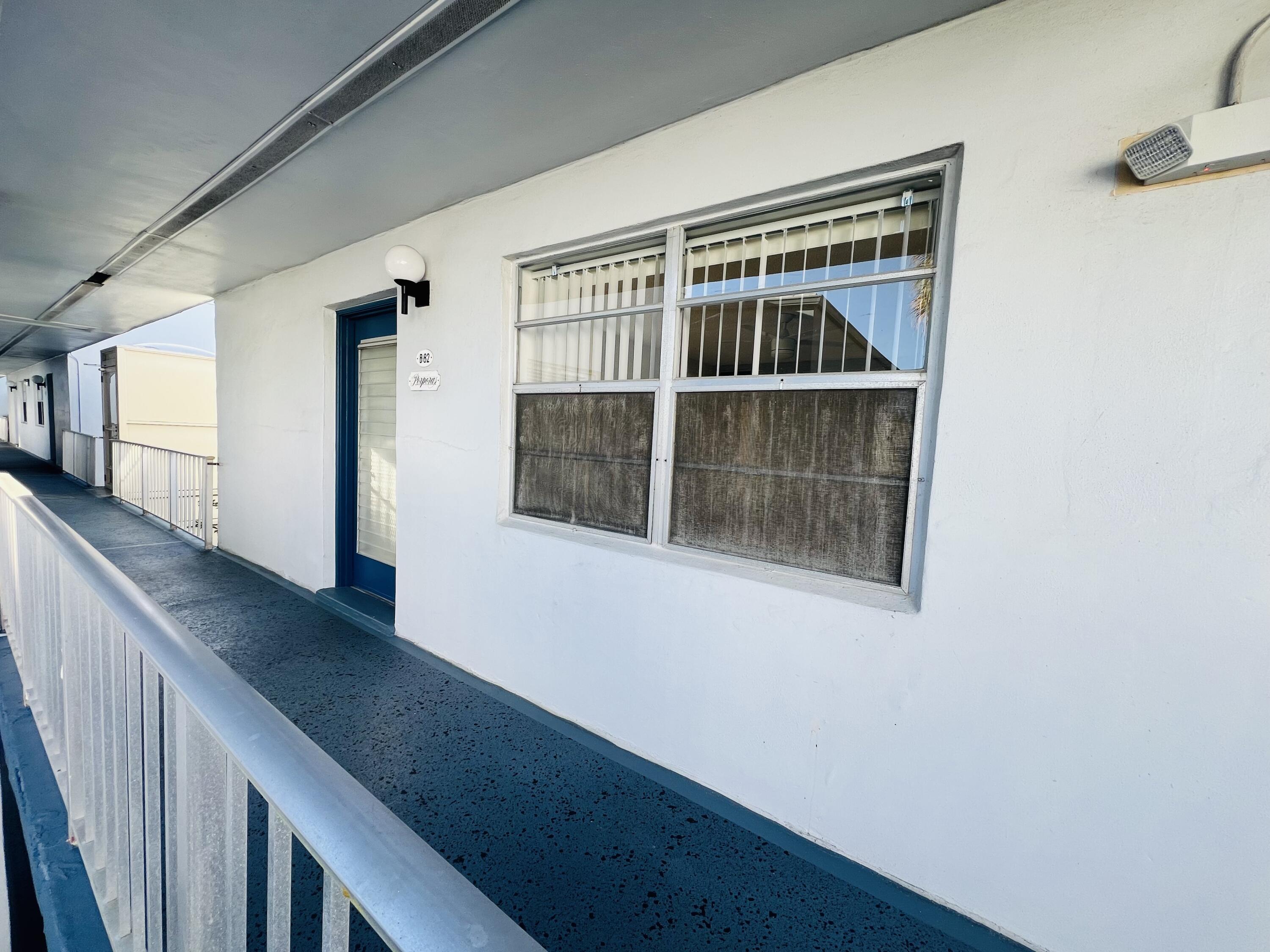82 Normandy B Delray Beach, FL 33484 - Photo 30 of 31 a view of a hallway with wooden floor and staircase