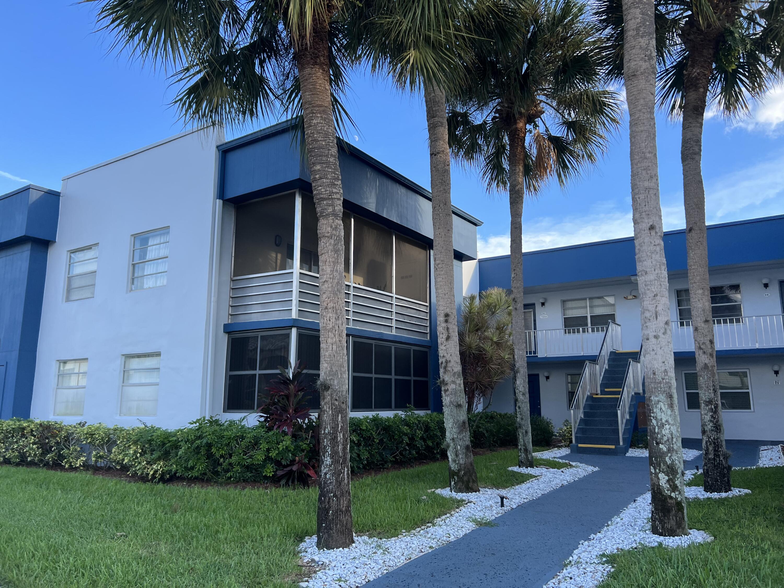 82 Normandy B Delray Beach, FL 33484 - Photo 31 of 31 a front view of a house with a garden