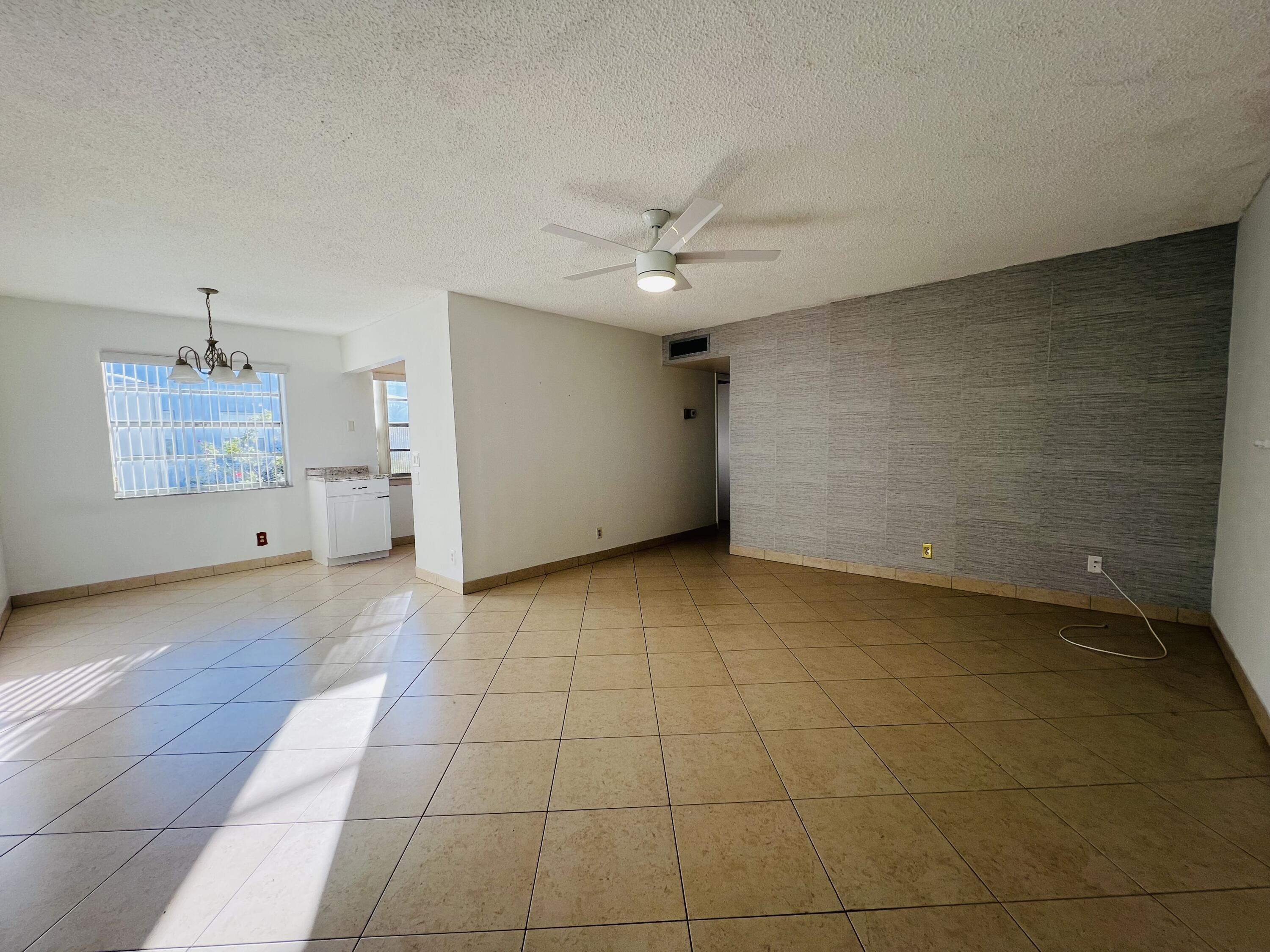 82 Normandy B Delray Beach, FL 33484 - Photo 7 of 31 a view of a livingroom with a projector and furniture
