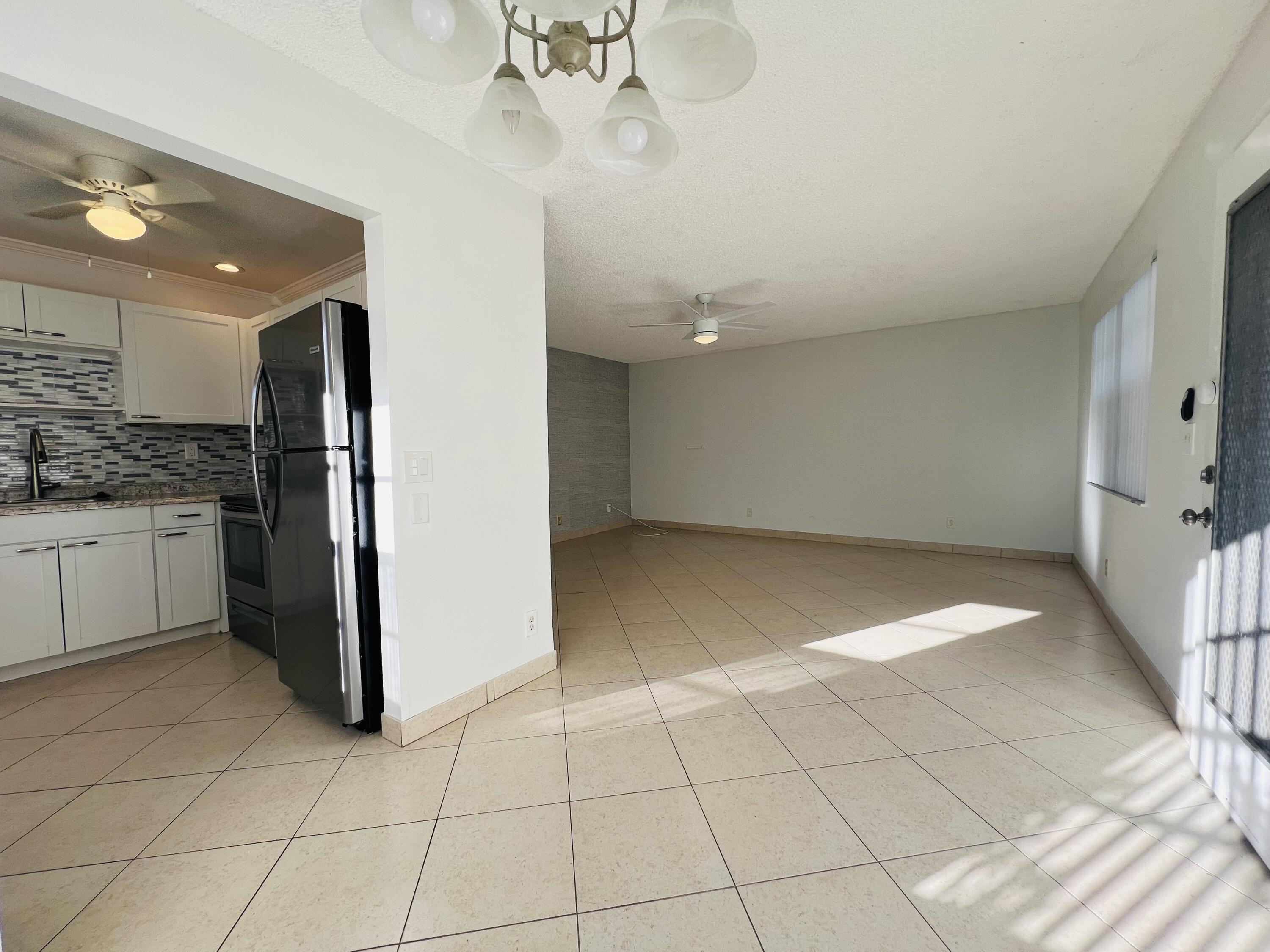 82 Normandy B Delray Beach, FL 33484 - Photo 9 of 31 a view of a kitchen with a sink and an oven cabinets