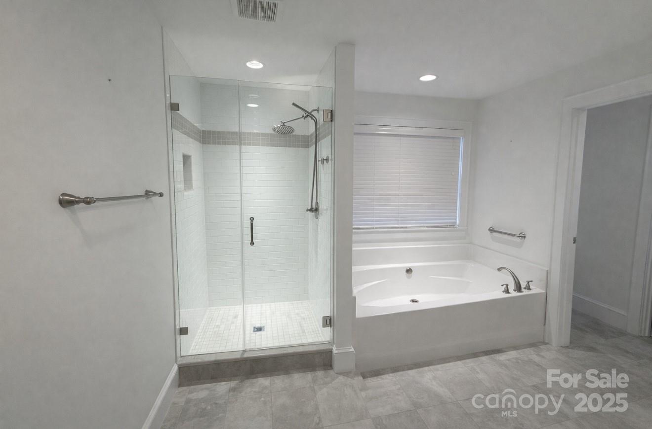 686 Elizabeth Street Southwest Concord, NC 28025 - Photo 11 of 44 a bathroom with a bathtub and a shower