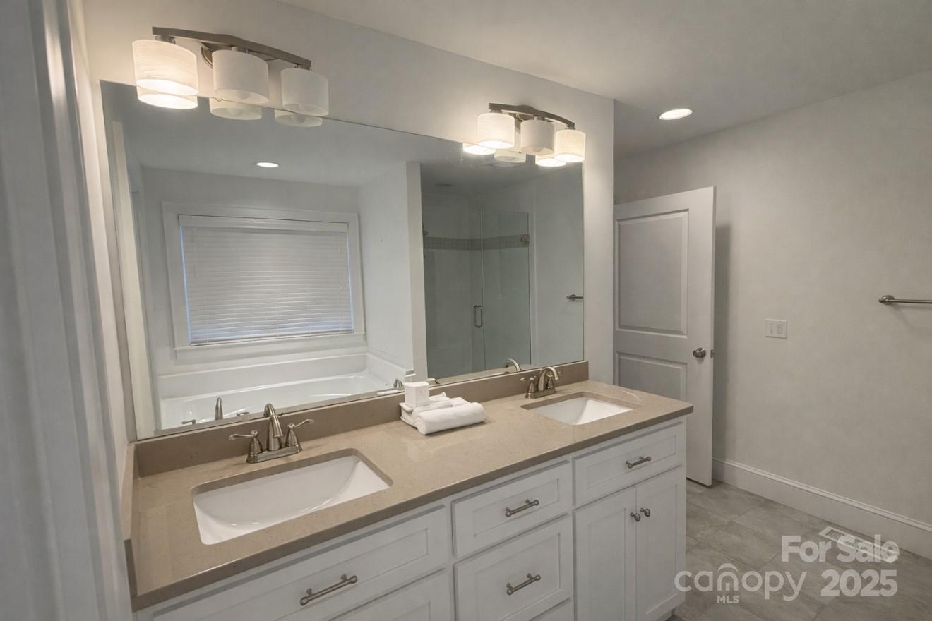 686 Elizabeth Street Southwest Concord, NC 28025 - Photo 13 of 44 a bathroom with a sink double vanity and a mirror