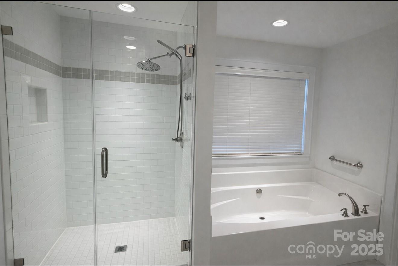 686 Elizabeth Street Southwest Concord, NC 28025 - Photo 14 of 44 a bathroom with a bathtub and a shower