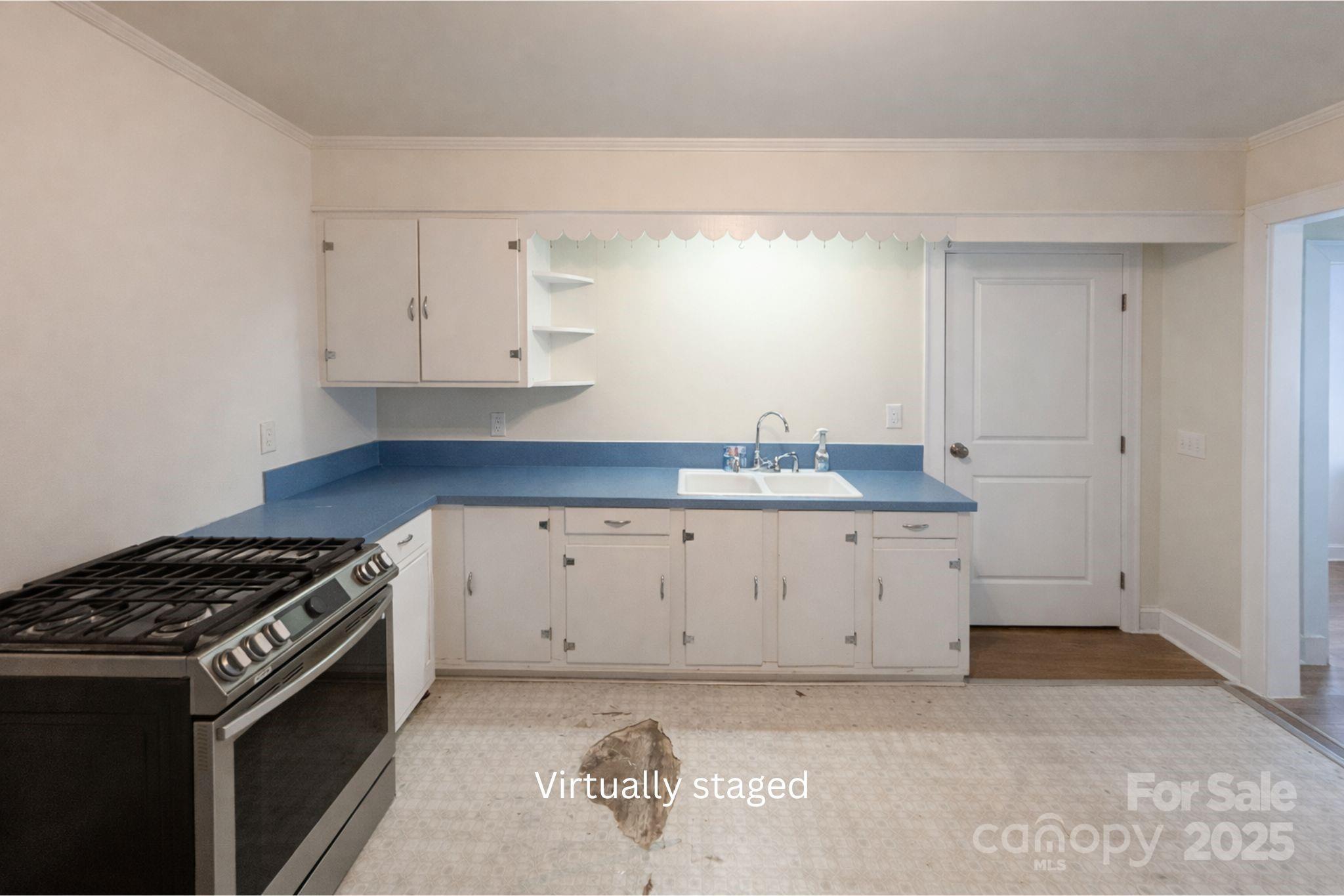 686 Elizabeth Street Southwest Concord, NC 28025 - Photo 15 of 44 a kitchen with granite countertop a stove and a sink