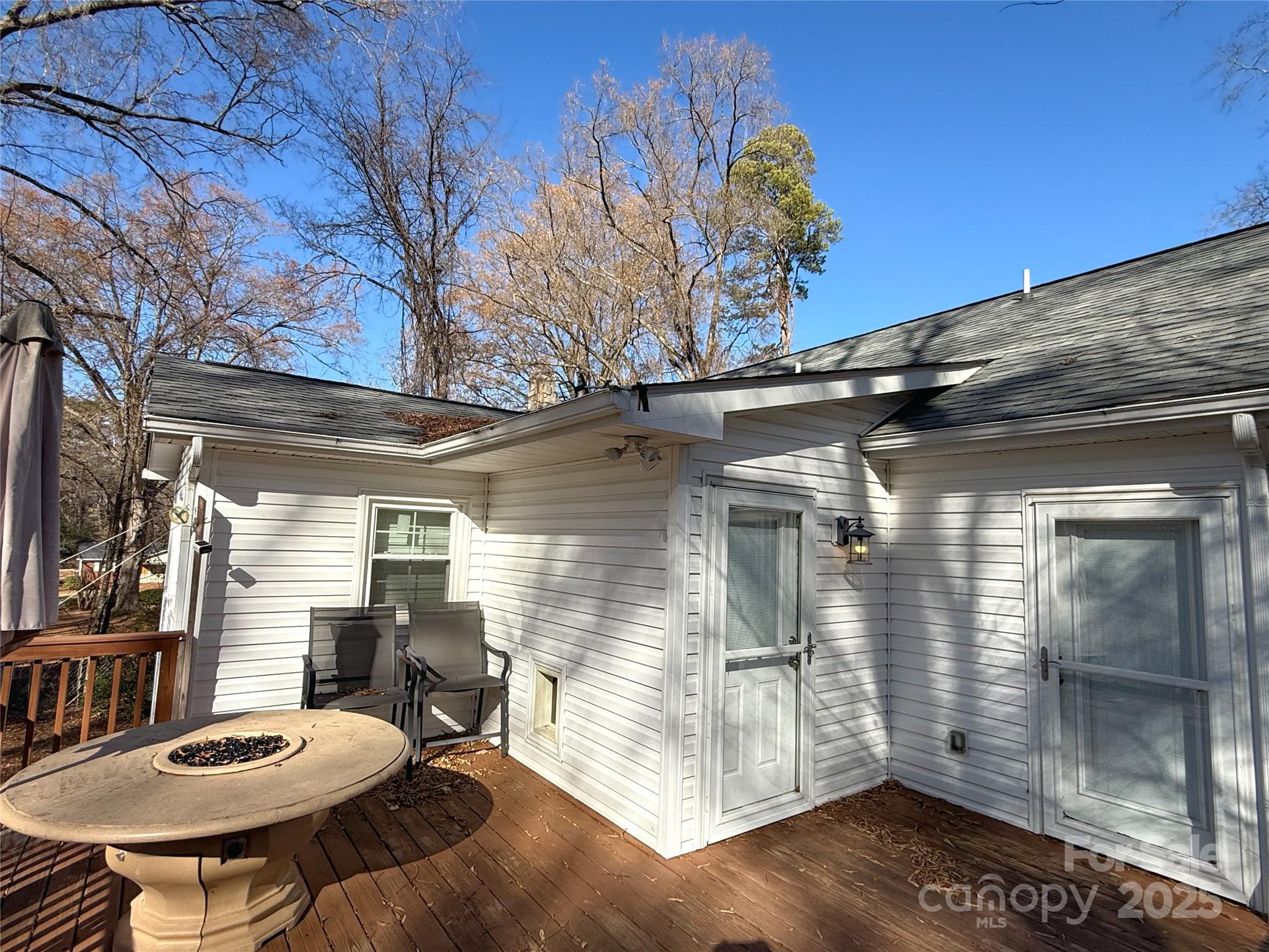 686 Elizabeth Street Southwest Concord, NC 28025 - Photo 25 of 44 a view of a patio with table and chairs with wooden floor and fence