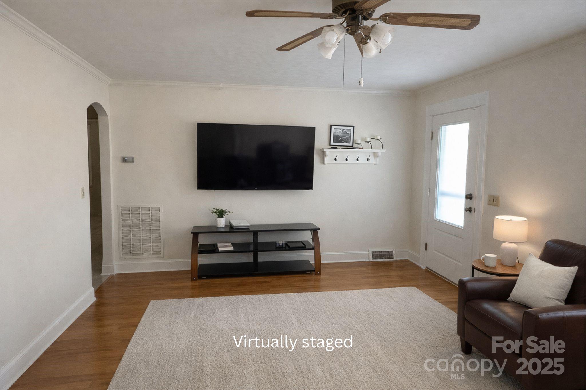 686 Elizabeth Street Southwest Concord, NC 28025 - Photo 6 of 44 a living room with furniture and a flat screen tv