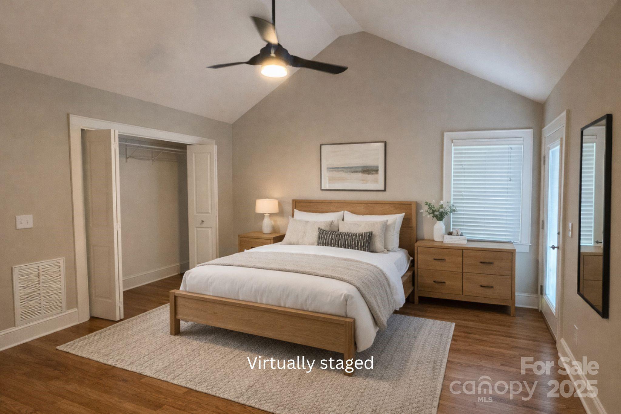 686 Elizabeth Street Southwest Concord, NC 28025 - Photo 7 of 44 a bedroom with a bed and a chandelier