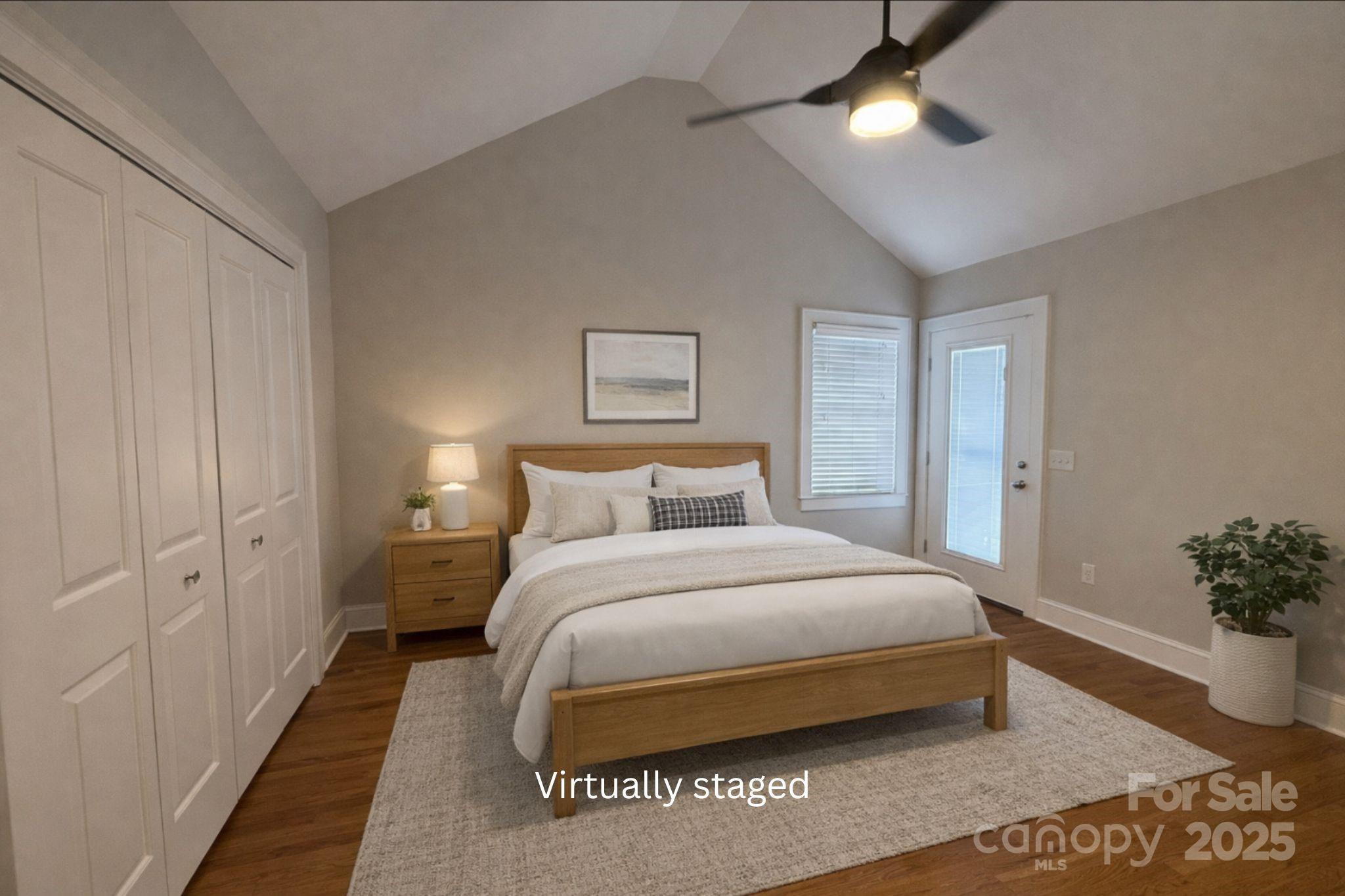 686 Elizabeth Street Southwest Concord, NC 28025 - Photo 8 of 44 a bedroom with a large bed and a chandelier