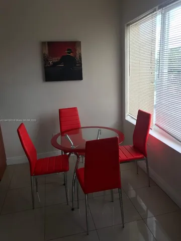 a living room with a couch and a potted plant