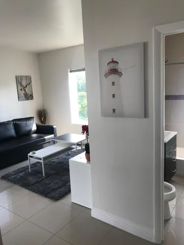 a living room with a couch and a window