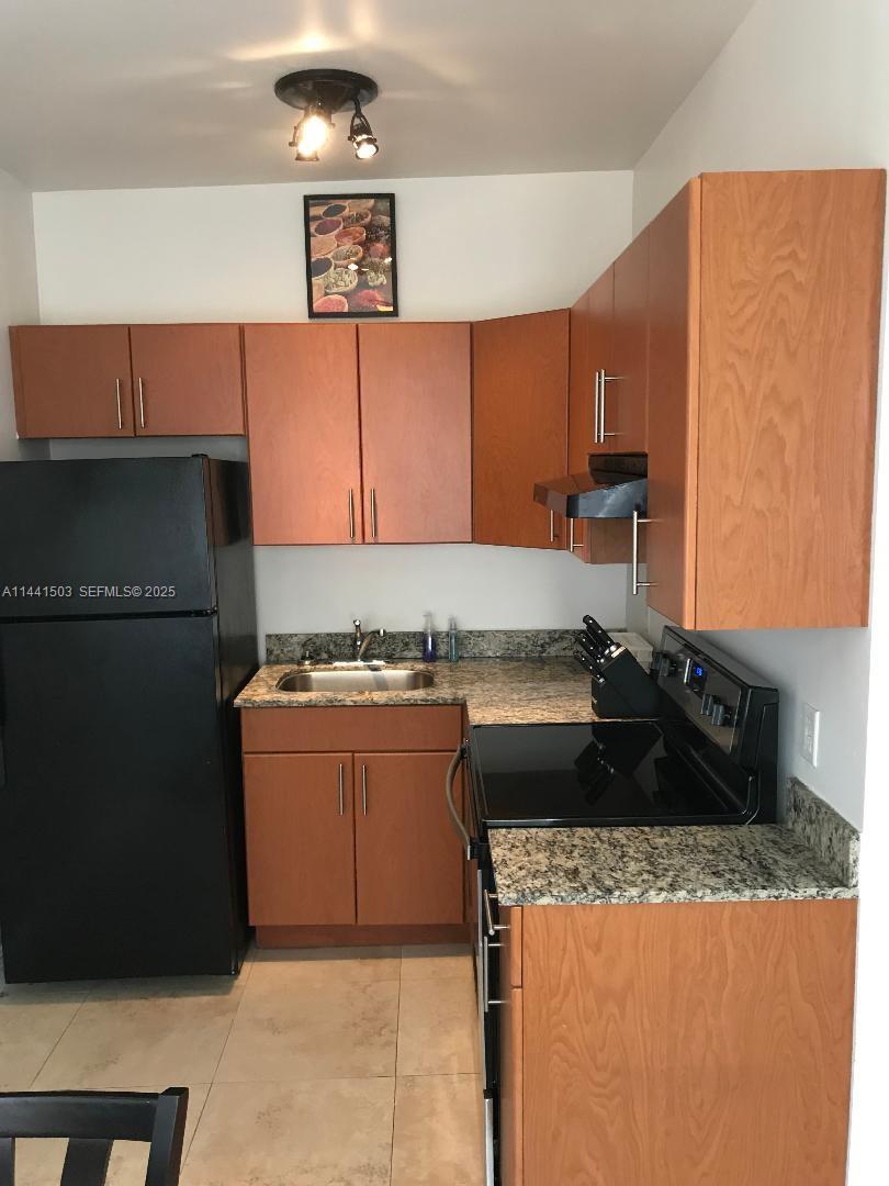440 Southwest 5th Avenue Miami, FL 33130 - Photo 24 of 46 a kitchen with a sink and a refrigerator