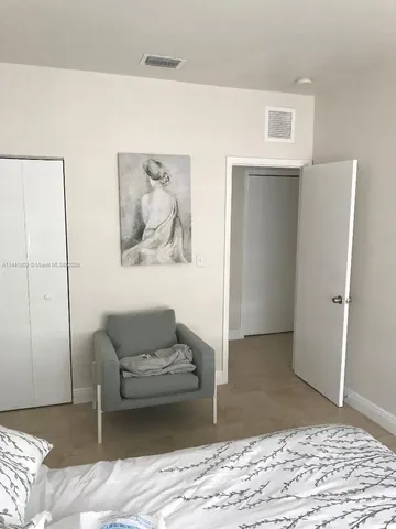 a bed sitting in a bedroom next to a window