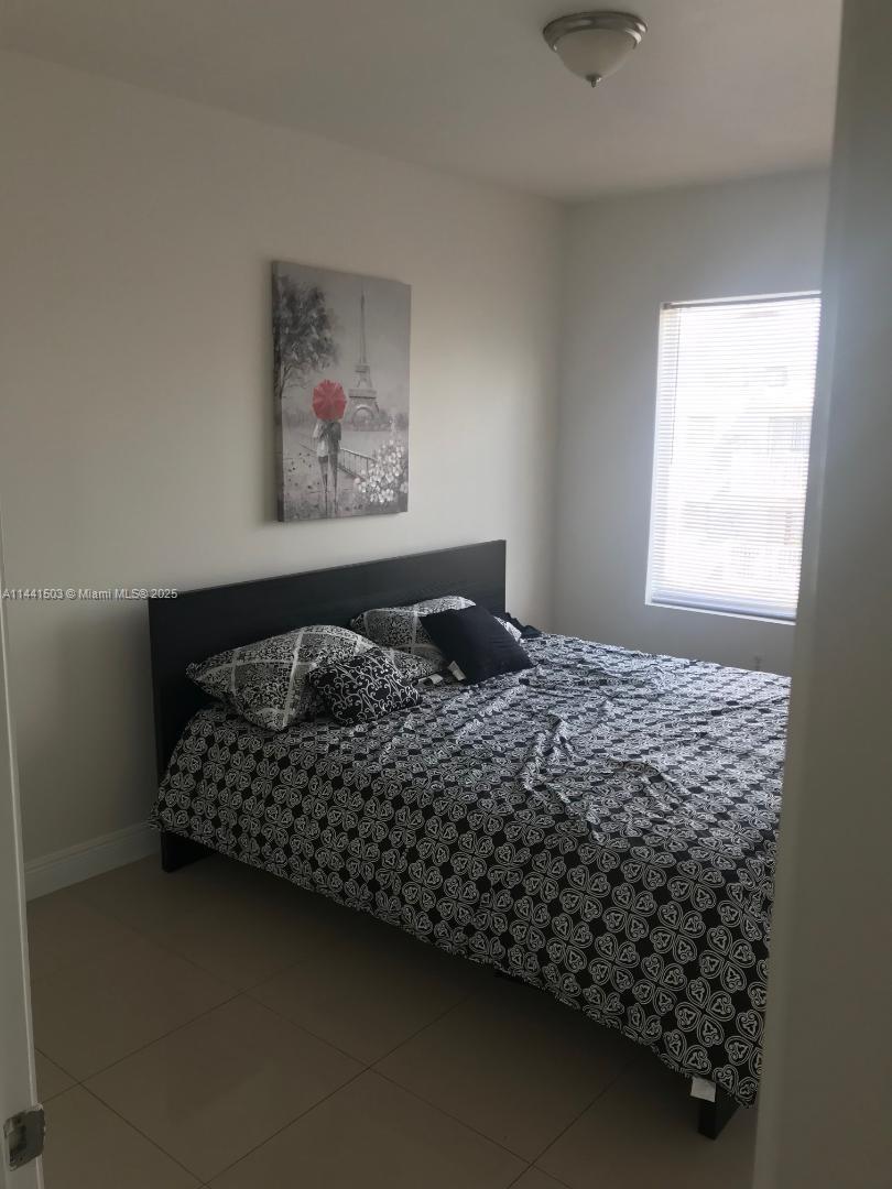 440 Southwest 5th Avenue Miami, FL 33130 - Photo 31 of 46 a bed sitting in a bedroom next to a window