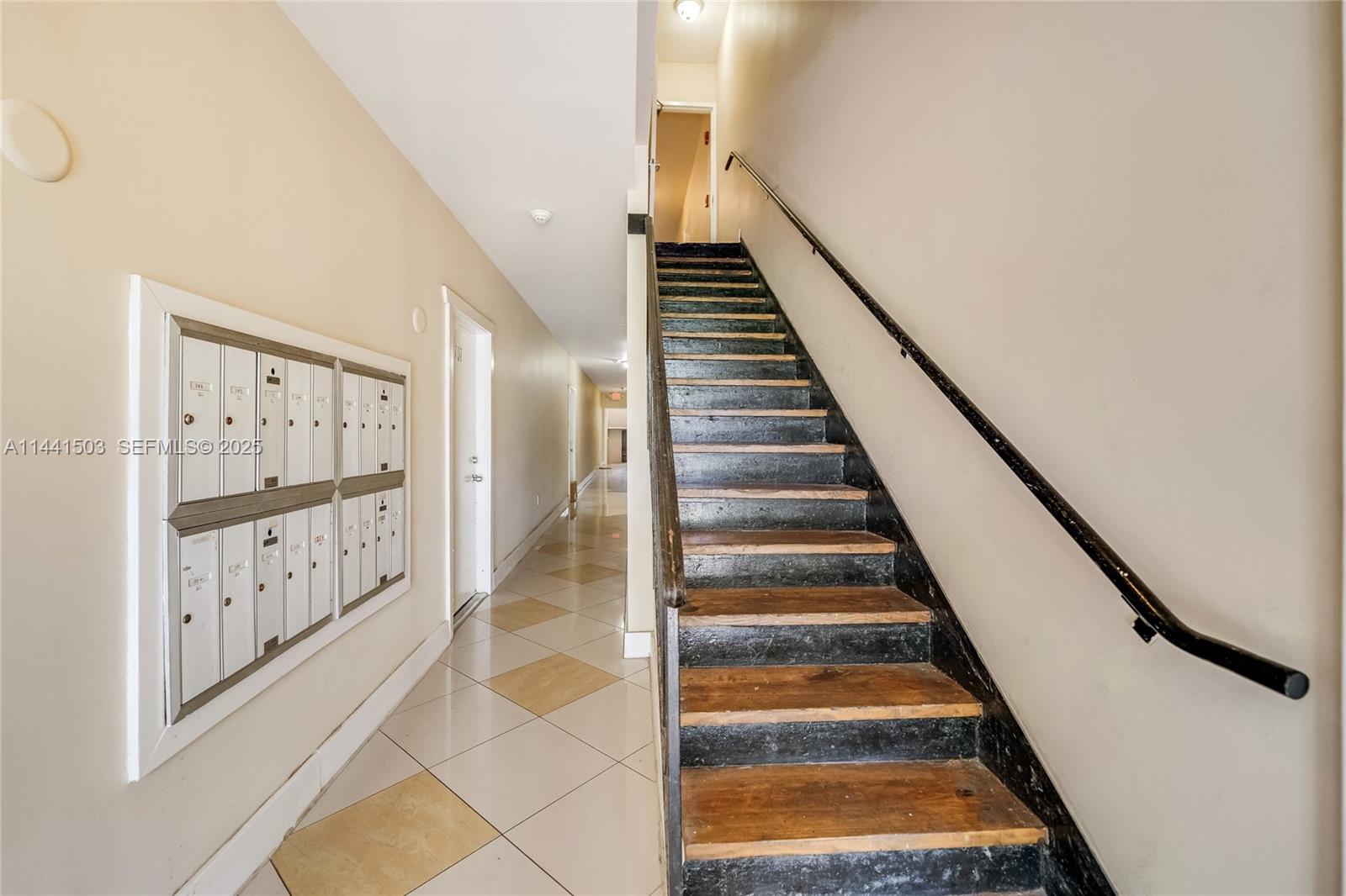 440 Southwest 5th Avenue Miami, FL 33130 - Photo 5 of 46 a view of staircase with lots of frames on wall and wooden floor