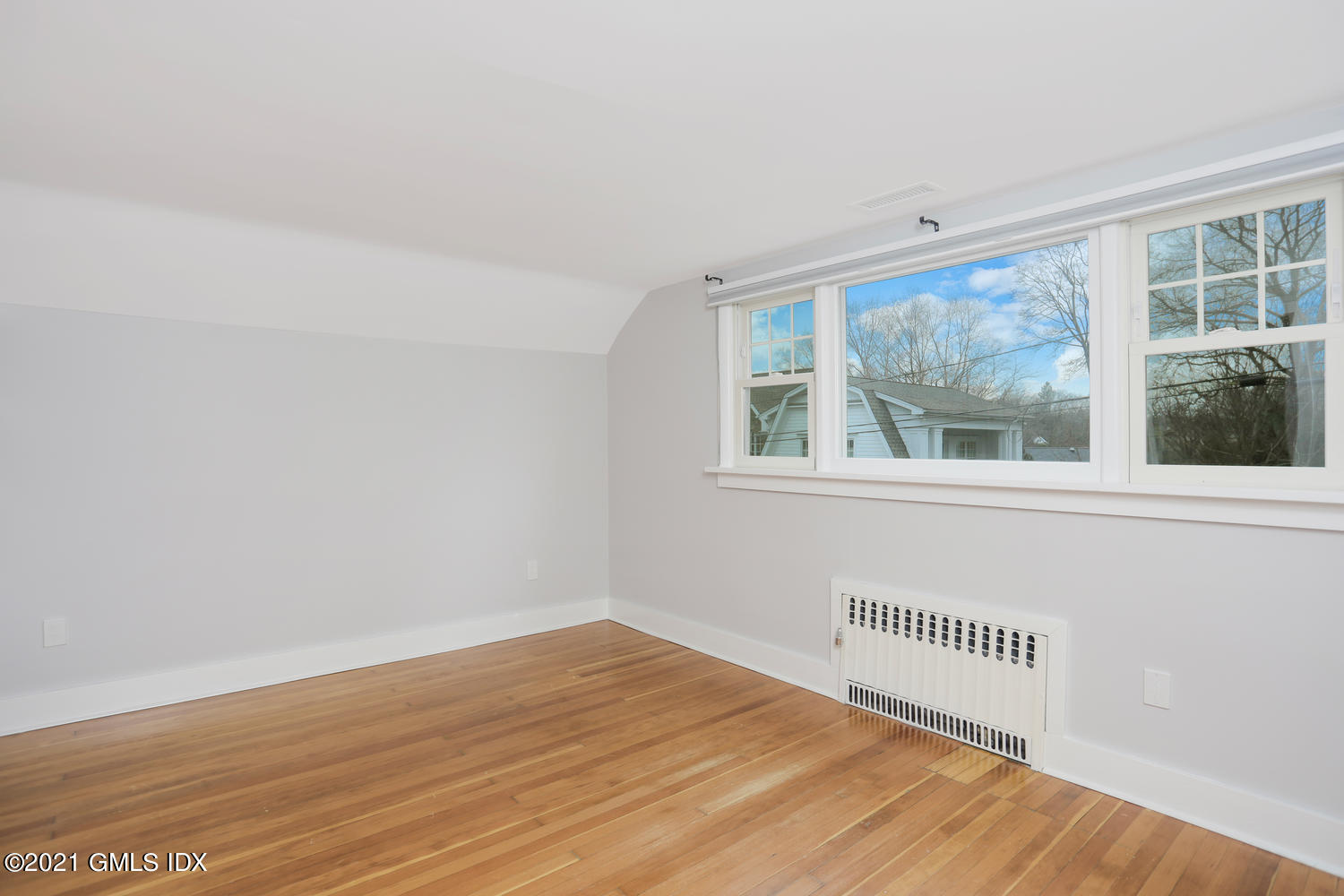 8 Potter Drive Old Greenwich, CT 06870 - Photo 9 of 11 a view of an empty room with wooden floor and a window