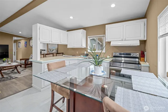 a kitchen with stainless steel appliances granite countertop a stove refrigerator sink and cabinets