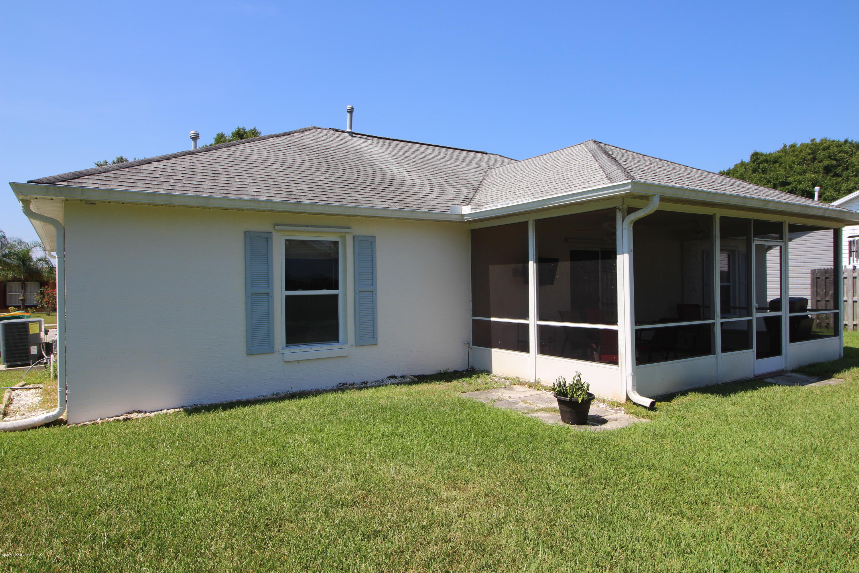 232 Oak Lake Road Melbourne, FL 32901 - Photo 22 of 23 a view of a house with a yard