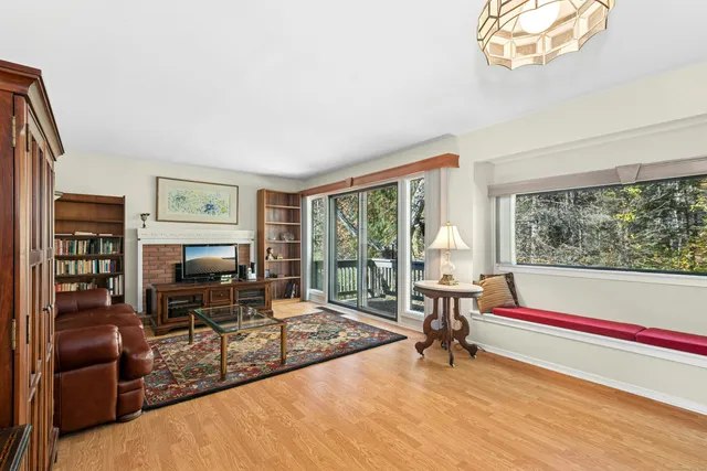 a living room with furniture and a floor to ceiling window