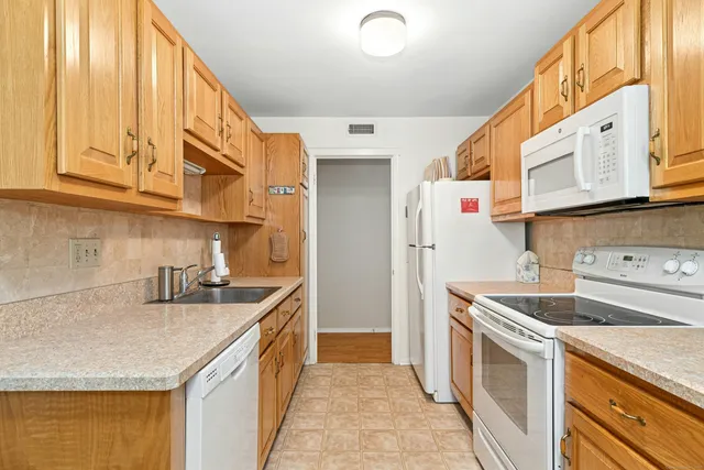 a kitchen with stainless steel appliances granite countertop a sink and cabinets