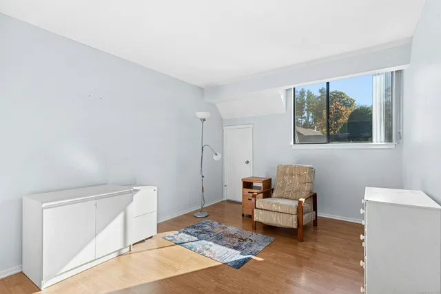 a living room with furniture and a baby crib