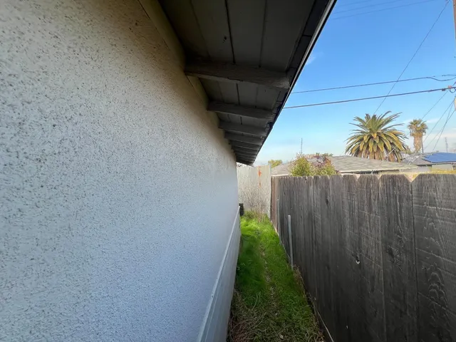 an empty room with windows and fireplace