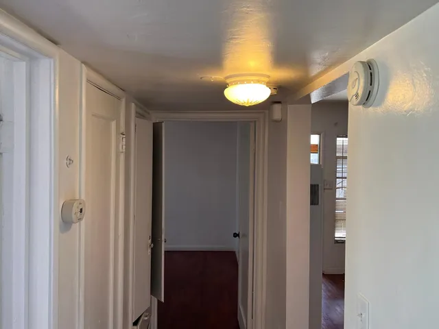 a bathroom with a sink vanity mirror and toilet