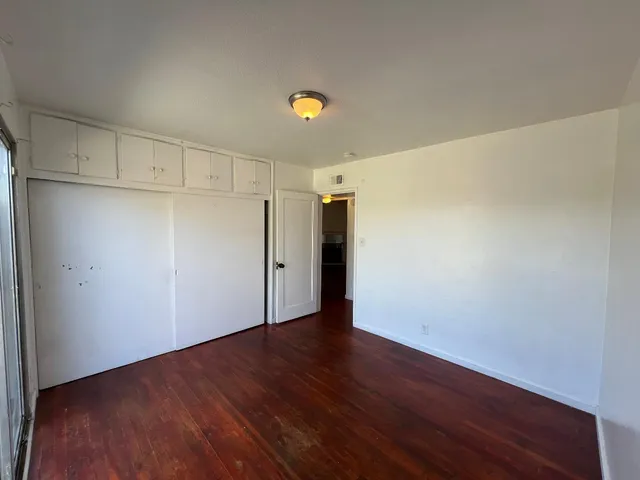 a bathroom with a granite countertop sink mirror vanity and toilet