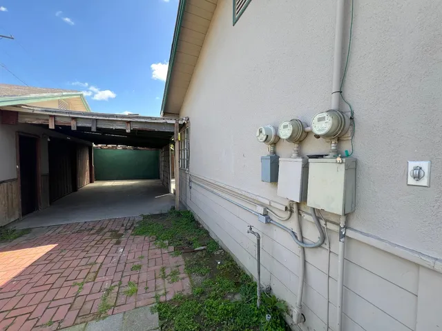 a view of an empty room with a fireplace and a window