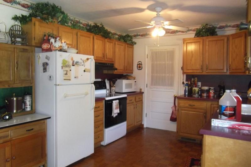 3728 Laurel Branch Road Northwest Floyd, VA 24091 - Photo 19 of 43 a kitchen with refrigerator a stove a sink and cabinets