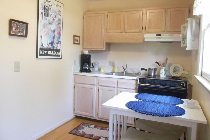 3728 Laurel Branch Road Northwest Floyd, VA 24091 - Photo 26 of 43 a kitchen with stainless steel appliances granite countertop a sink dishwasher a stove and white cabinets with wooden floor
