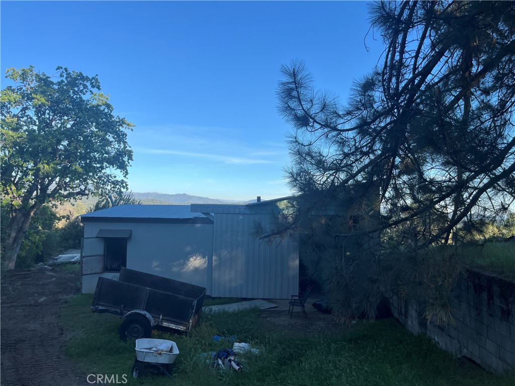 5643 Carleton Road Mariposa, CA 95338 - Photo 8 of 22 a view of a backyard with plants and a fire pit