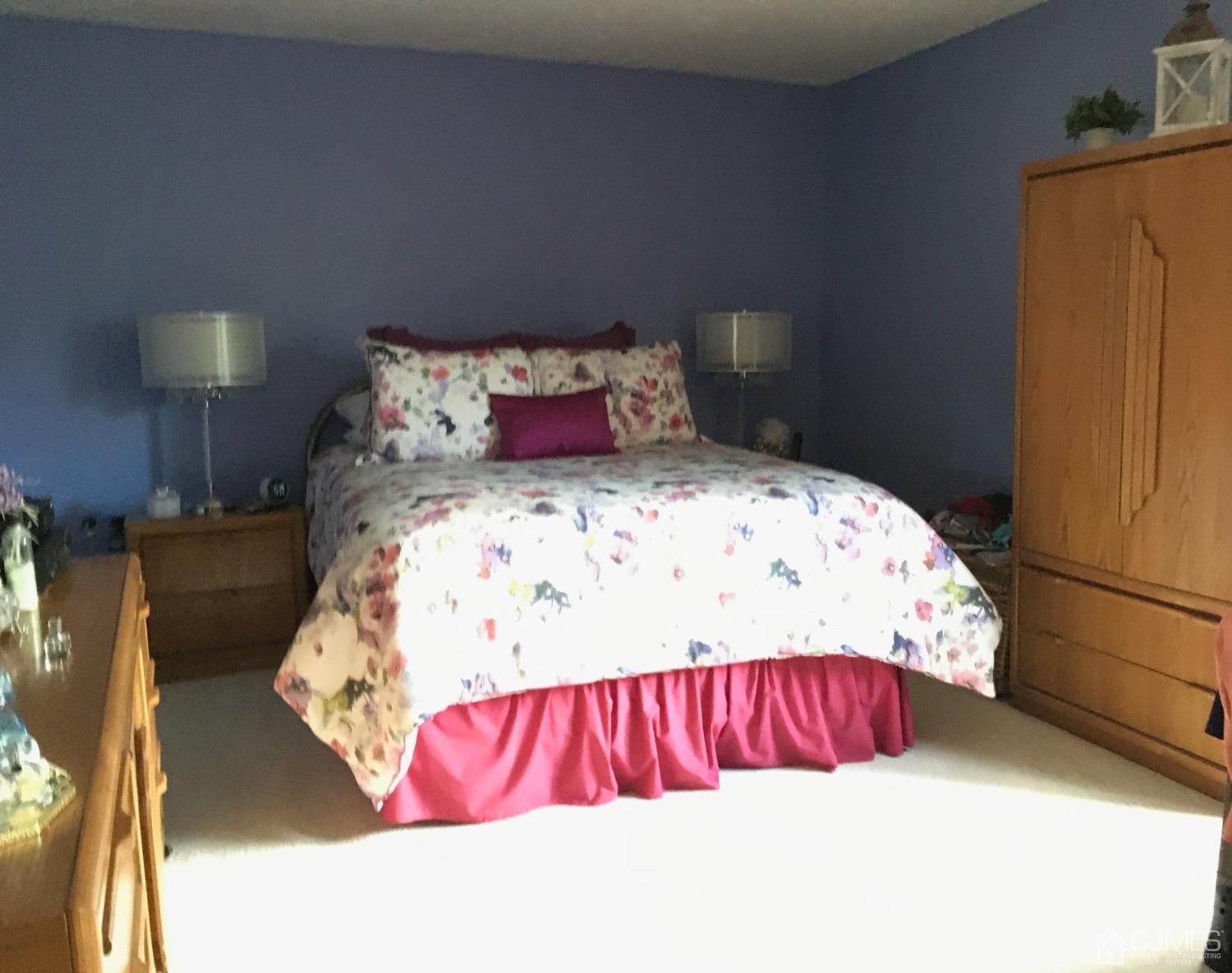 1517 Raspberry Court Edison, NJ 08817 - Photo 15 of 15 a bed sitting in a bedroom next to a lamp