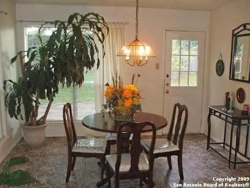 a dining room with furniture and window
