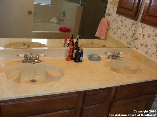 a bathroom with a sink and a mirror