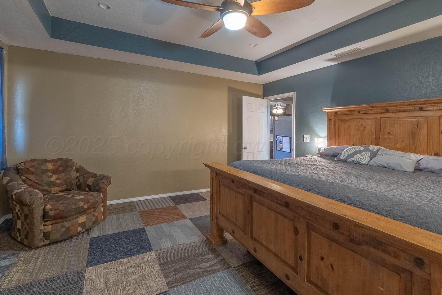 428 Overland Trail Fritch, TX 79036 - Photo 12 of 24 a bedroom with a bed and ceiling fan