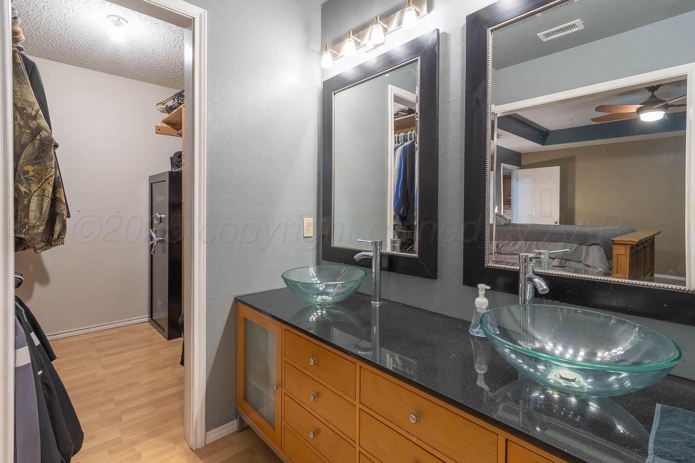 428 Overland Trail Fritch, TX 79036 - Photo 13 of 24 a bathroom with double vanity and a mirror
