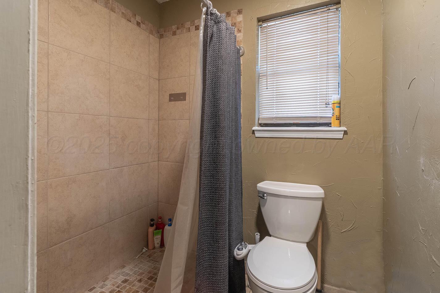 428 Overland Trail Fritch, TX 79036 - Photo 14 of 24 a white toilet sitting next to a bathroom sink