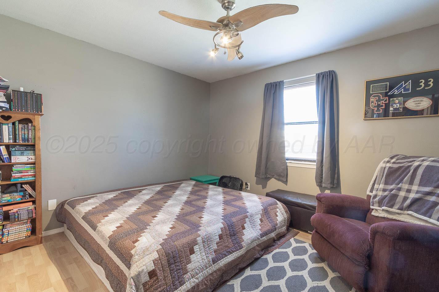 428 Overland Trail Fritch, TX 79036 - Photo 17 of 24 a bedroom with a bed and a chandelier