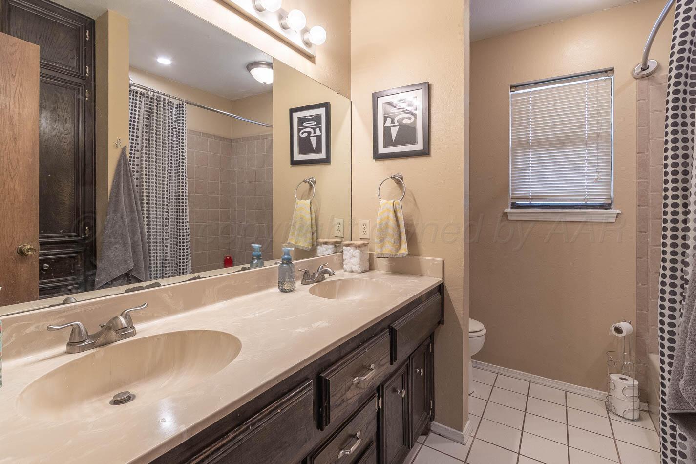 428 Overland Trail Fritch, TX 79036 - Photo 18 of 24 a bathroom with double vanity and a two mirror