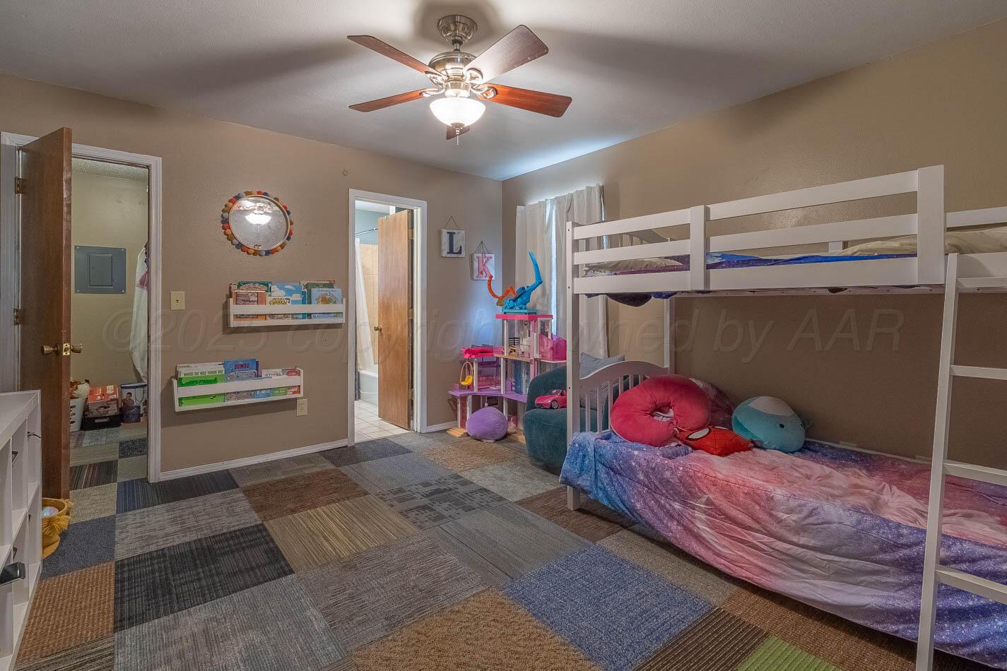 428 Overland Trail Fritch, TX 79036 - Photo 19 of 24 a bedroom with a bed and a chandelier