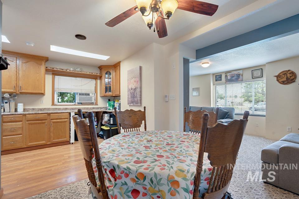 1015 East Park Street Weiser, ID 83672 - Photo 11 of 30 Dining room with a skylight, ceiling fan, and light wood finished floors