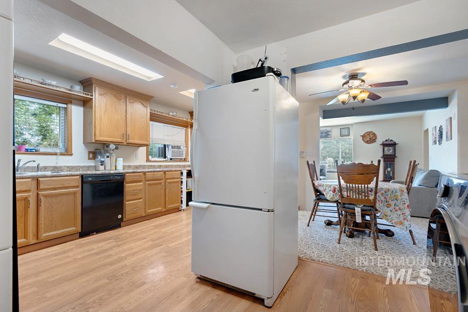 1015 East Park Street Weiser, ID 83672 - Photo 16 of 30 Kitchen with freestanding refrigerator, healthy amount of natural light, black dishwasher, and light wood-style floors