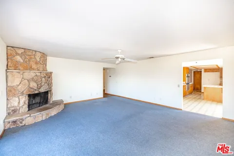 a view of an empty room with a fireplace