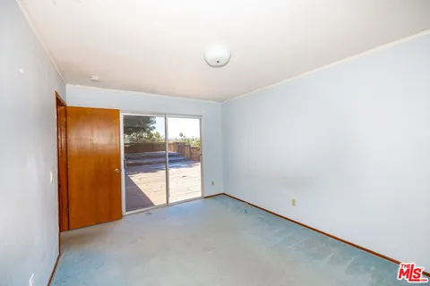 an empty room with glass door