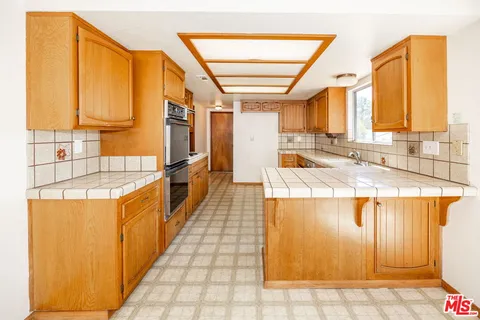 a kitchen with stainless steel appliances granite countertop a sink and cabinets