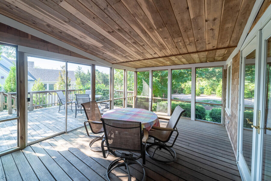7 Point Hill Road West Barnstable, MA 02668 - Photo 13 of 28 a view of a dining room with furniture wooden floor and outside view