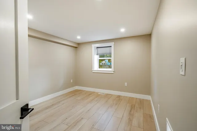 a view of room with window and hardwood floor
