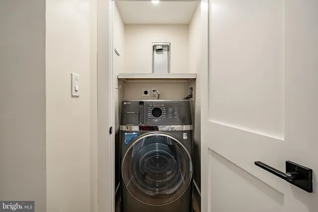 a view of a hallway with washer and dryer