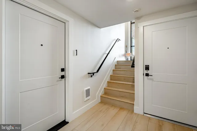 a view of entryway with stairs and wooden floor